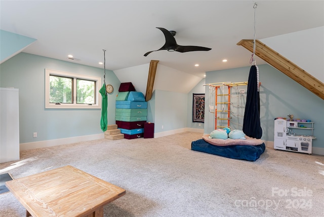 playroom featuring lofted ceiling, carpet flooring, and ceiling fan