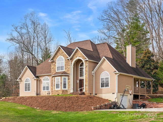 back of house featuring a yard and a garage