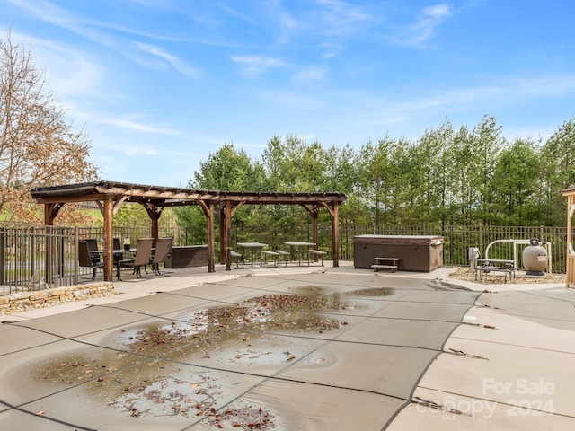 view of terrace featuring a hot tub and a pergola