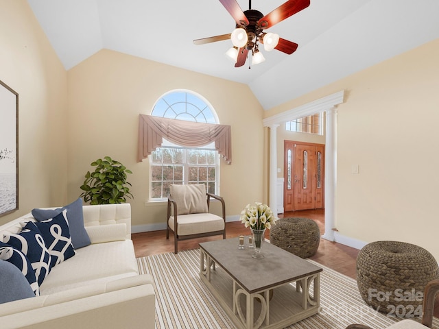 living room with lofted ceiling, ceiling fan, and light wood-type flooring