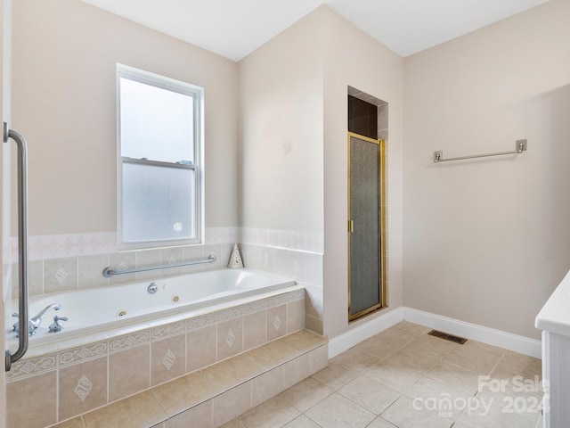 bathroom with separate shower and tub and tile flooring