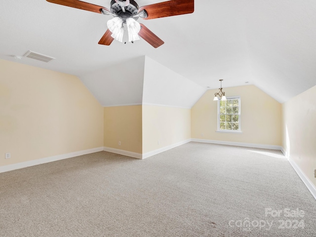 additional living space featuring light carpet, ceiling fan, and vaulted ceiling