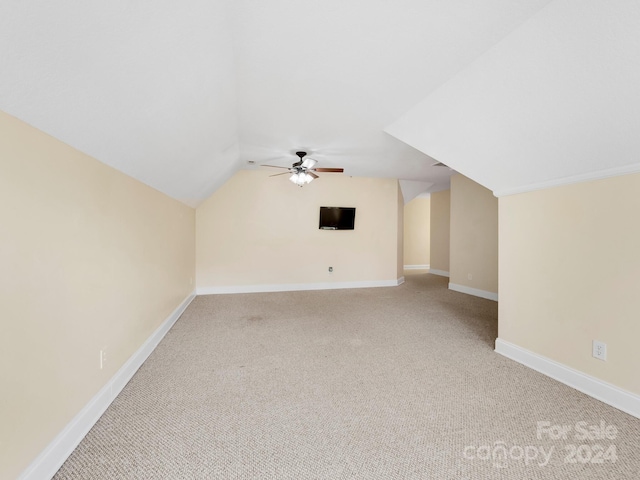 bonus room with light colored carpet, vaulted ceiling, and ceiling fan