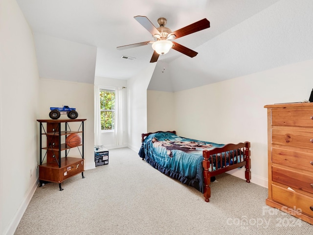 carpeted bedroom with ceiling fan and vaulted ceiling