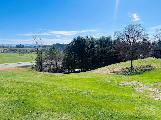 exterior space with a rural view and a lawn