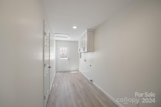 corridor with light hardwood / wood-style flooring