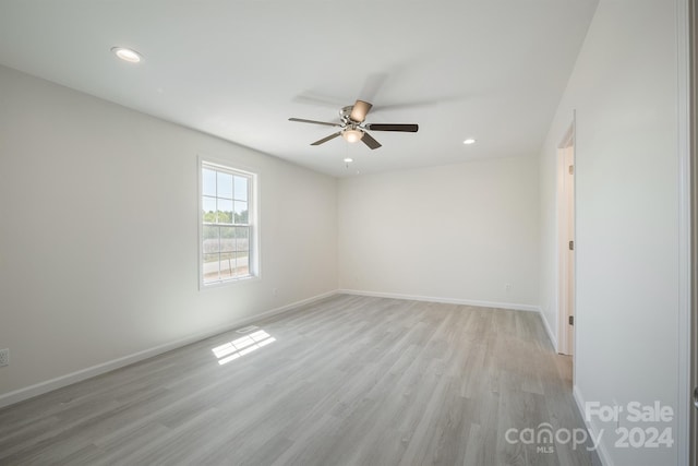 empty room with light hardwood / wood-style floors and ceiling fan