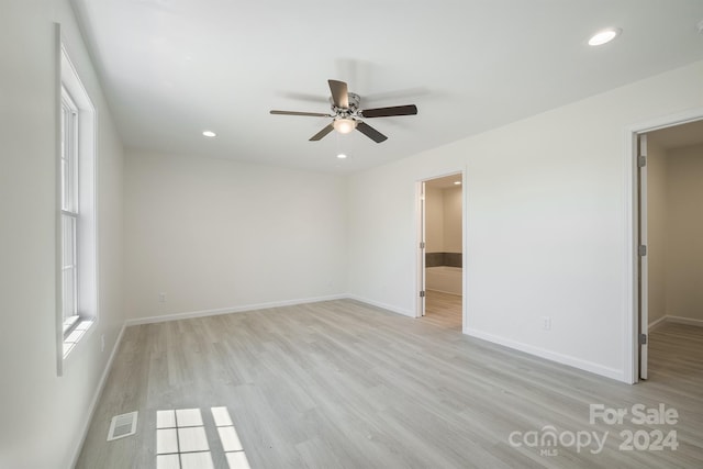 spare room with light hardwood / wood-style flooring and ceiling fan