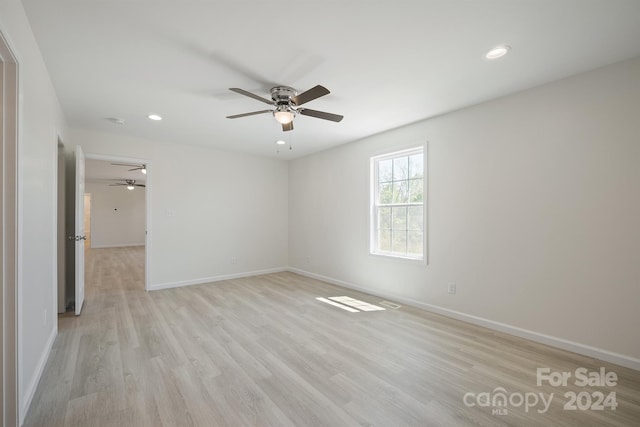 unfurnished room with ceiling fan and light wood-type flooring