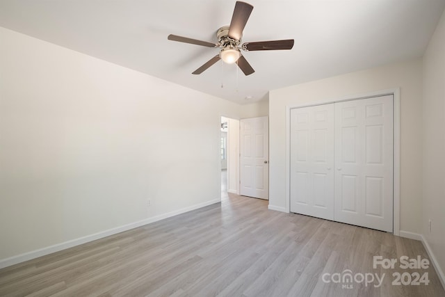 unfurnished bedroom featuring a closet, ceiling fan, and light wood-type flooring