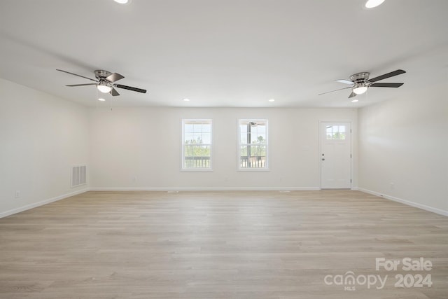 unfurnished room with light hardwood / wood-style flooring and ceiling fan