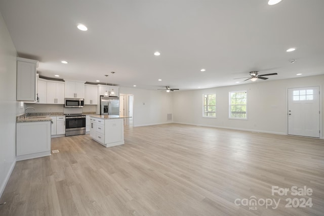 kitchen featuring ceiling fan, light hardwood / wood-style flooring, stainless steel appliances, and a center island