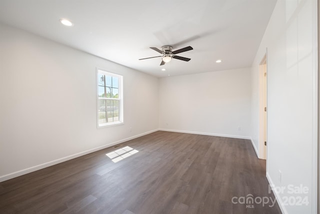 empty room featuring dark wood-type flooring and ceiling fan