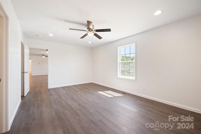 spare room featuring ceiling fan and dark wood-type flooring