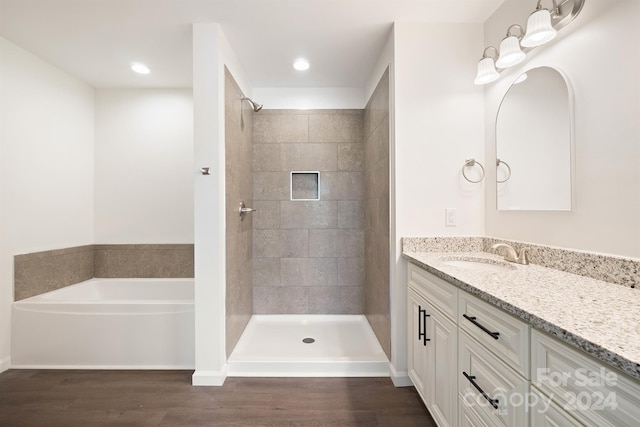 bathroom featuring independent shower and bath, oversized vanity, and hardwood / wood-style flooring