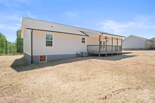 rear view of house with a deck and cooling unit