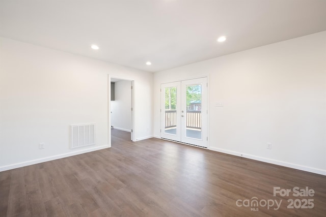 empty room featuring french doors and dark hardwood / wood-style floors