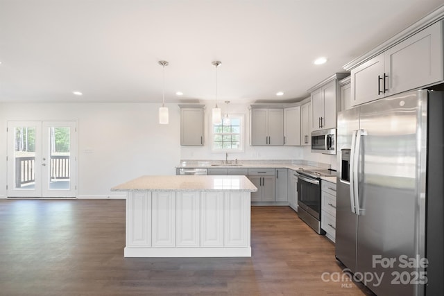 kitchen with sink, gray cabinetry, stainless steel appliances, and decorative light fixtures