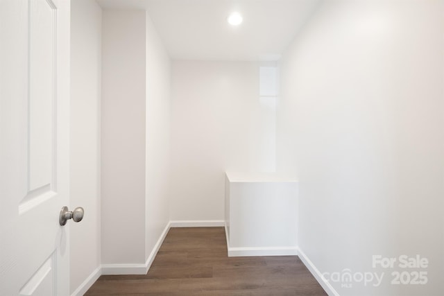 corridor with dark hardwood / wood-style floors