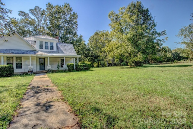 view of front facade with covered porch and a front yard