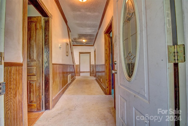 hallway featuring light carpet and crown molding