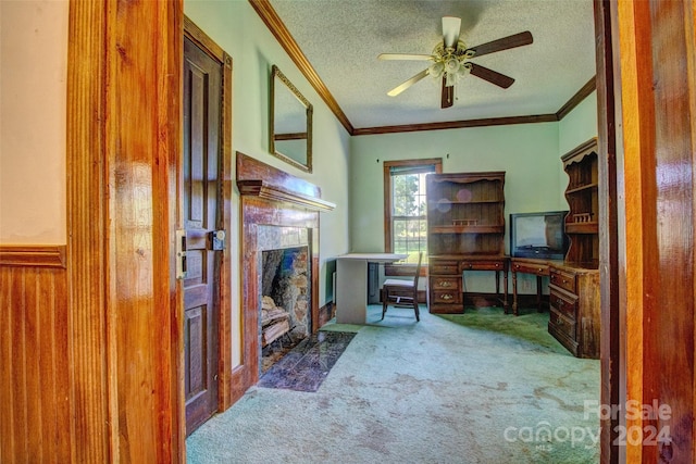 carpeted office featuring ornamental molding, a textured ceiling, and ceiling fan