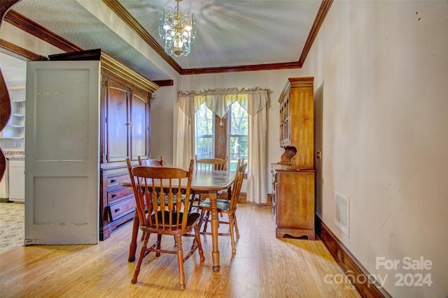 dining room featuring a chandelier, crown molding, and light hardwood / wood-style flooring