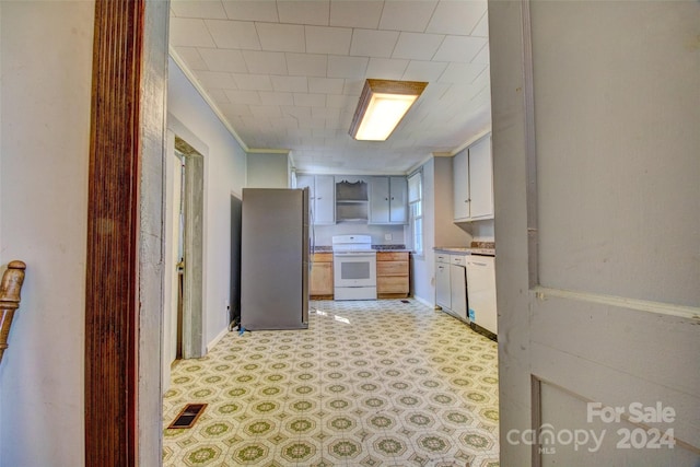 kitchen with light tile floors, fume extractor, and white appliances