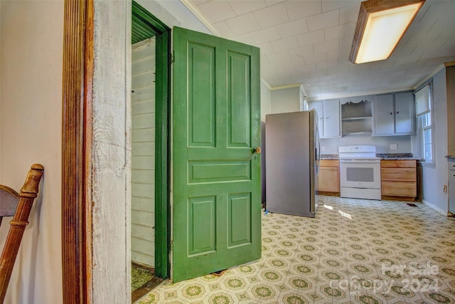 kitchen with crown molding, white range with electric cooktop, stainless steel fridge, and light tile floors