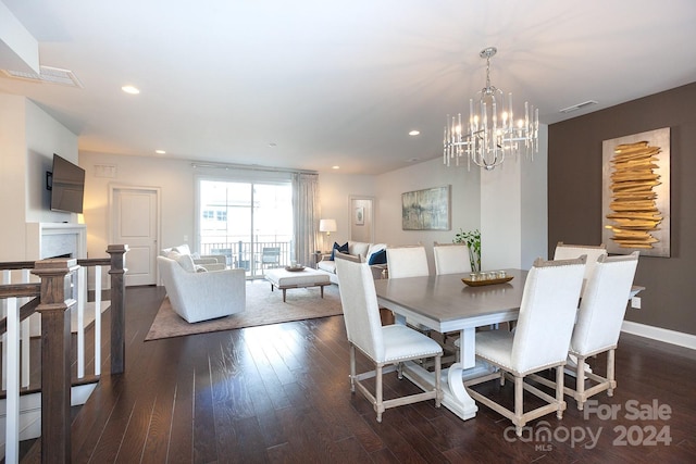 dining space featuring dark hardwood / wood-style flooring and an inviting chandelier