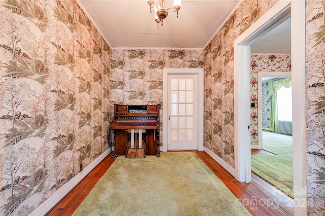 miscellaneous room featuring ornamental molding, a chandelier, radiator, and dark hardwood / wood-style floors