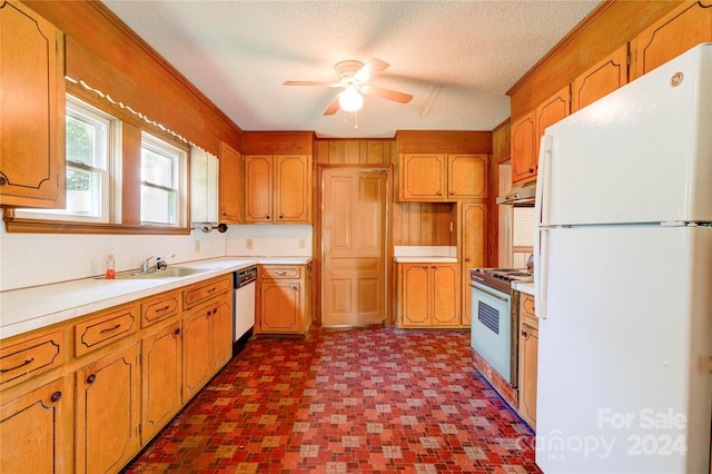 kitchen featuring dishwashing machine, gas range oven, white fridge, dark tile flooring, and ceiling fan