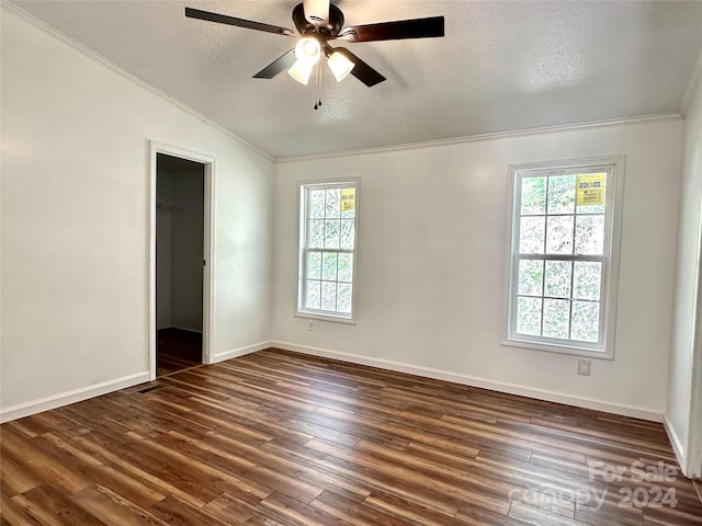 spare room featuring ceiling fan, plenty of natural light, dark wood-type flooring, and lofted ceiling