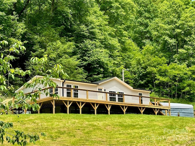 back of house with a lawn