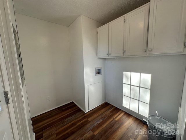 clothes washing area featuring cabinets, hookup for a washing machine, a textured ceiling, and dark wood-type flooring