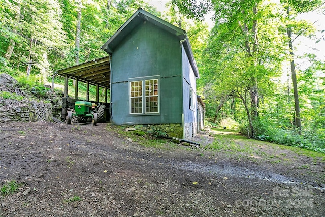 view of property exterior featuring an outdoor structure