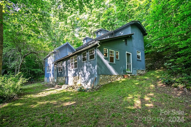 rear view of property featuring a yard