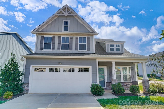 craftsman house with a porch and a garage