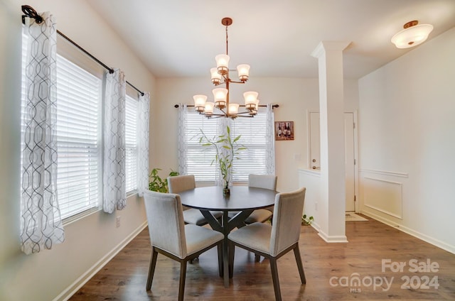 dining area featuring dark wood-type flooring and a chandelier