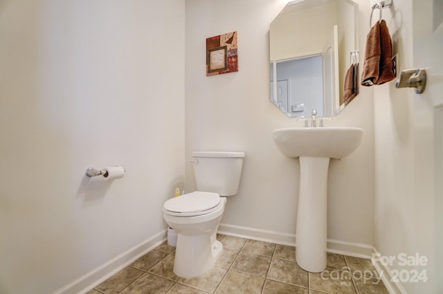 bathroom featuring sink, tile floors, and toilet