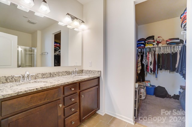 bathroom with tile floors and double vanity