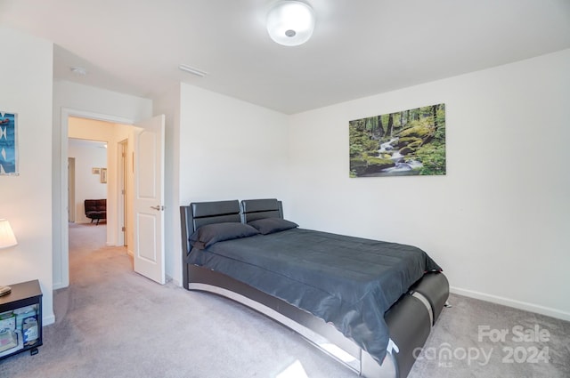 bedroom featuring light carpet