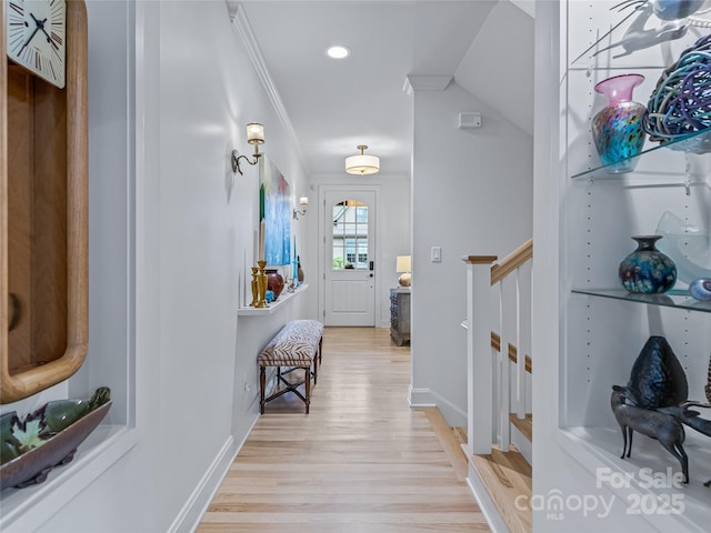 interior space featuring light wood-type flooring and ornamental molding