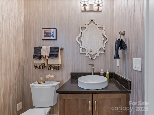 bathroom featuring toilet and vanity