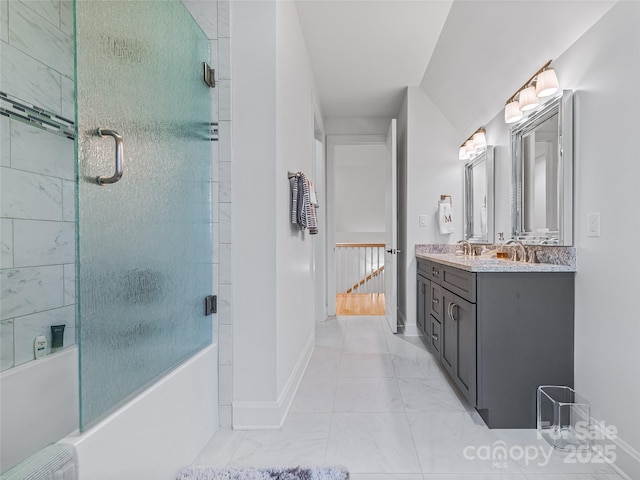 bathroom featuring shower / bath combination with glass door and vanity