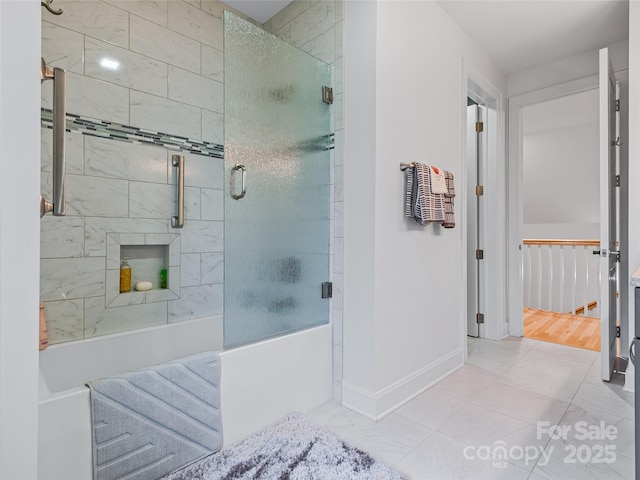 bathroom featuring combined bath / shower with glass door and tile patterned flooring