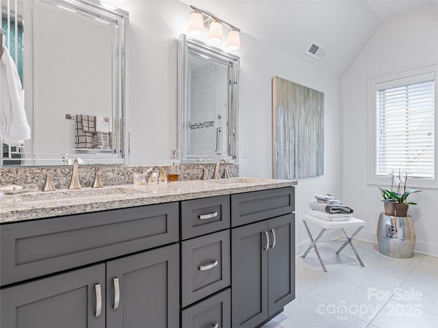 bathroom featuring tile patterned floors, vanity, and lofted ceiling