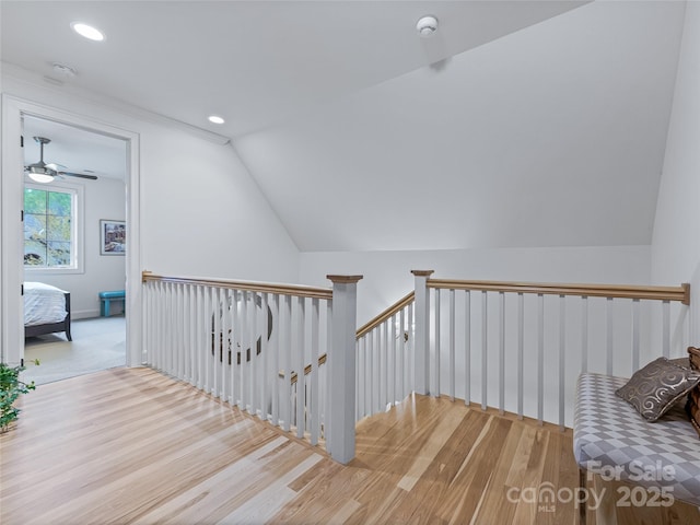 stairs with lofted ceiling and wood-type flooring