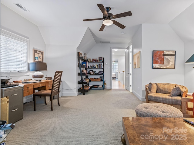 office space with light carpet, ceiling fan, vaulted ceiling, and plenty of natural light