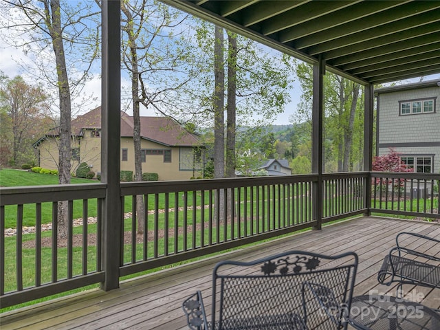 wooden deck featuring a yard